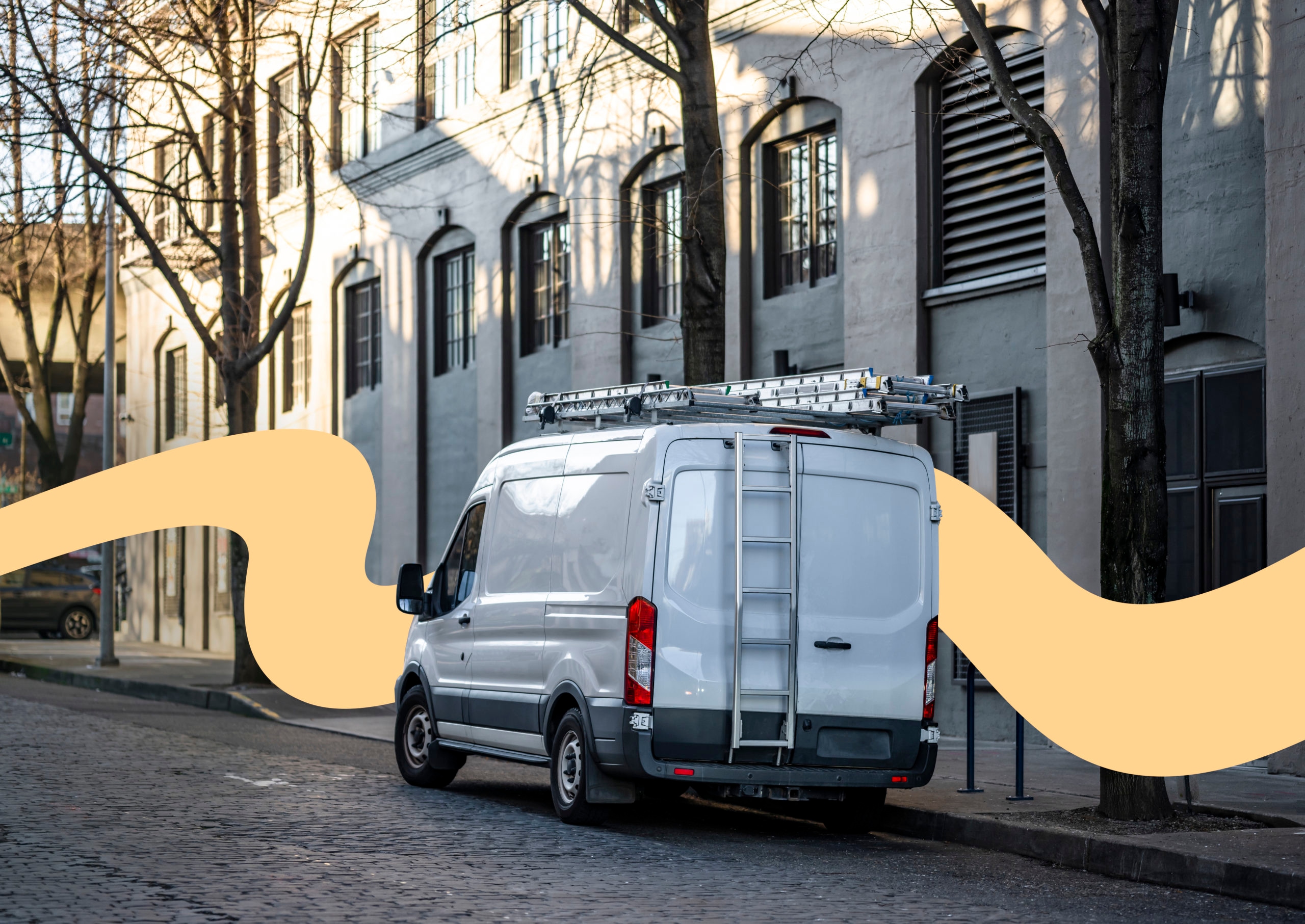 Small compact cargo mini van with ladder on the roof standing on the city street with multilevel buildings